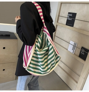 Detail of colorful striped canvas tote bag showing spacious design and wide strap