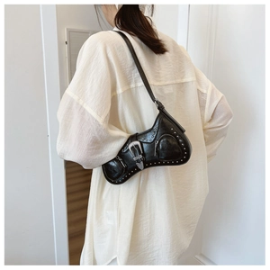Detailed view of black PU leather moon bag featuring silver studs and vintage metal buckle