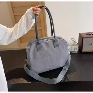 Detail view of grey canvas crossbody bag with double handles and Enjoy Life print text
