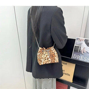 Detail showing leopard print bucket bag with silver chain strap and pearl charms