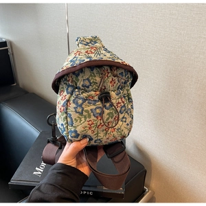 Floral jacquard fabric crossbody chest bag with adjustable strap and drawstring closure