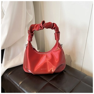 Detail of red PU crescent bag featuring a scrunchie handle and MUDUO logo design