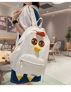 Close-up of white nylon chicken shaped backpack with plush charm and zipper pocket