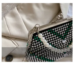 Detail showing the vintage metal hook and intricate rhinestone craftsmanship on the bag