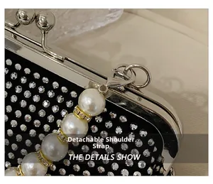 Detail of luxurious black velvet evening bag with sparkling rhinestones and detachable pearl strap