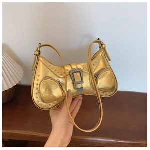Metallic gold PU handbag with silver rivets and vintage buckle in a lifestyle setting