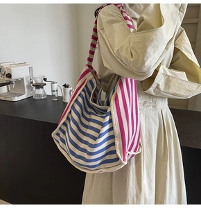 Close-up of the large capacity striped canvas tote bag showing soft texture and roomy design