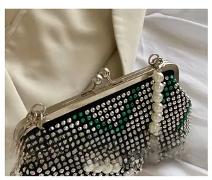 Detail of vintage metal clasp and large pearl handle on a rhinestone evening clutch bag