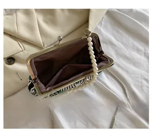 Detail showing the brown satin interior and open pocket of the rhinestone evening bag