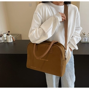 Detail of large brown canvas travel tote with Enjoy Life print and adjustable strap