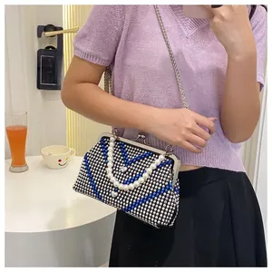 Sparkling rhinestone dinner bag with pearl handle and chain strap on a model