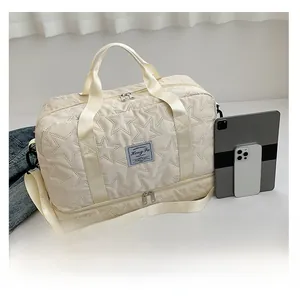 Macro detail of large cream quilted crossbody bag with star pattern and dual compartments