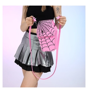 Pink coffin-shaped PU leather crossbody bag featuring a black spider web design on model