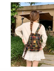 Detail view of colorful wool plaid backpack with adjustable brown straps in outdoor setting
