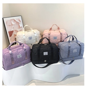 Detail of five multi-color quilted star pattern travel bags with adjustable straps