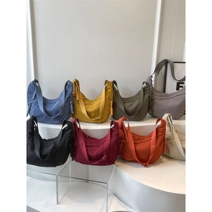 Large nylon dumpling crossbody bag displayed in eight versatile colors for casual daily commute