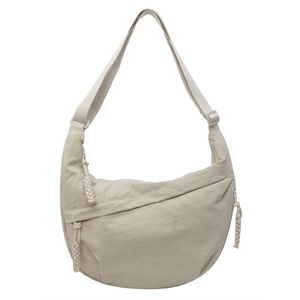Minimalist beige nylon half-moon crossbody bag with adjustable strap and textured surface