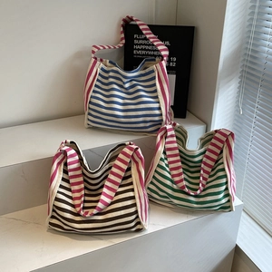Three striped knit tote bags in blue, coffee, and green with stylish pink straps