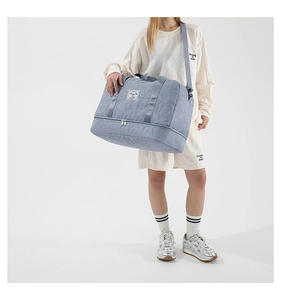 Detail of blue travel bag with star quilted pattern and independent shoe compartment