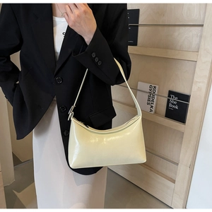 Polished light yellow PU leather half-moon hobo bag styled with a professional black blazer