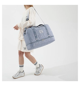 Blue quilted star travel bag detail showing the separate bottom shoe compartment and strap