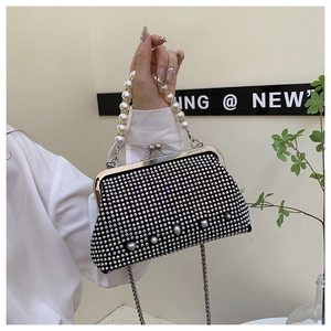 Detailed shot of black rhinestone crossbody bag with pearl handle and metal chain