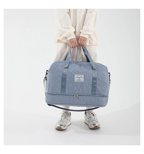 Macro detail of light blue star-quilted travel bag with independent bottom zipper layer