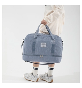 Detail of light blue quilted travel bag with independent shoe compartment at the bottom