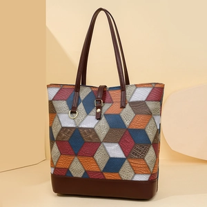 Detail of multi-color geometric patchwork tote bag with crocodile texture and metal buckle