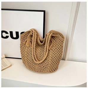 Chic woven straw tote bag in natural brown with bohemian tassels for summer style