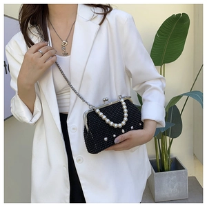 Detail of black rhinestone evening bag with heart pearls and elegant pearl handle