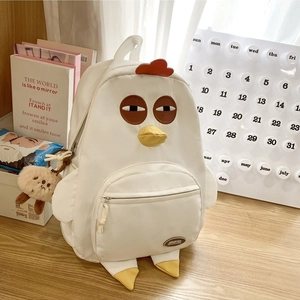 Cute white nylon chicken backpack with red comb and bear pendant in cozy room