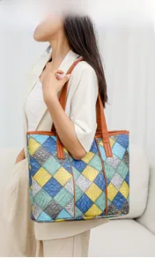Detail of color-block tote bag with crocodile pattern and stylish diamond patchwork design