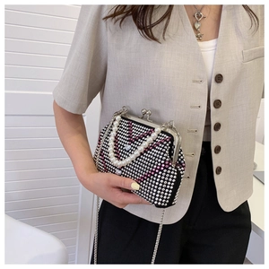 Detail view of rhinestone evening bag with pink V-pattern, pearl handle, and chain strap