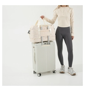 Macro detail of star quilted travel bag with luggage sleeve attachment on suitcase