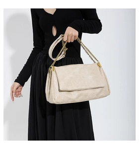 Chic beige PU leather handbag with gold chain strap and elegant pleated texture