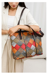 Detailed view of colorful patchwork tote bag with crocodile and snake skin textures