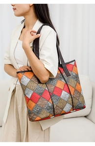 Detail of checkered patchwork tote bag with crocodile texture and long shoulder straps