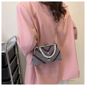 Detailed close-up of rhinestone evening bag with red V-pattern and pearl chain handle