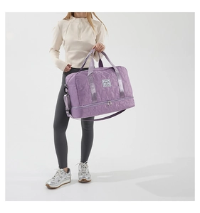 Detail of lavender quilted nylon gym bag featuring a separate bottom shoe compartment