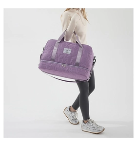 Detail of purple star-quilted travel bag showing reinforced handles and bottom zip compartment