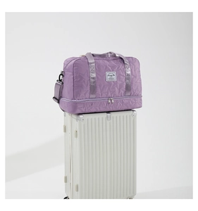 Close-up of purple star-quilted travel bag with a separate shoe compartment on luggage