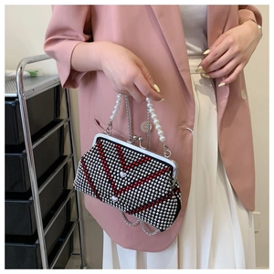 Detail view of sparkly rhinestone V-pattern evening bag with faux pearl handle