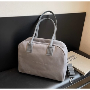 Minimalist grey canvas handbag with travel slogan print and detachable shoulder strap