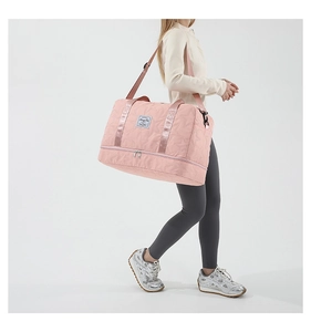 Pink star-quilted travel bag featuring a separate bottom shoe compartment and crossbody strap