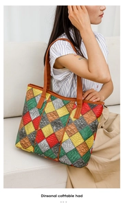 Detail of colorful patchwork tote bag with crocodile texture and thin shoulder straps
