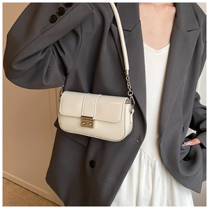 Chic cream PU leather crossbody bag with silver metal buckle shown on a female model