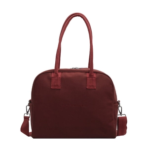 Minimalist burgundy canvas tote bag with woven handles and detachable shoulder strap