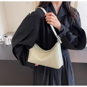 Detail of light green PU leather hobo bag with adjustable strap and silver metal hardware