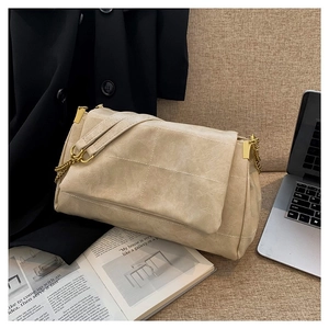 Minimalist beige faux leather crossbody bag with lychee texture and gold chain strap
